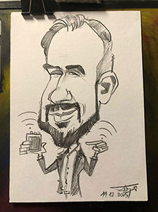 Umelec Janko víta hostí na firemnom večierku v Bratislave rýchlou karikatúrou pri vstupe.